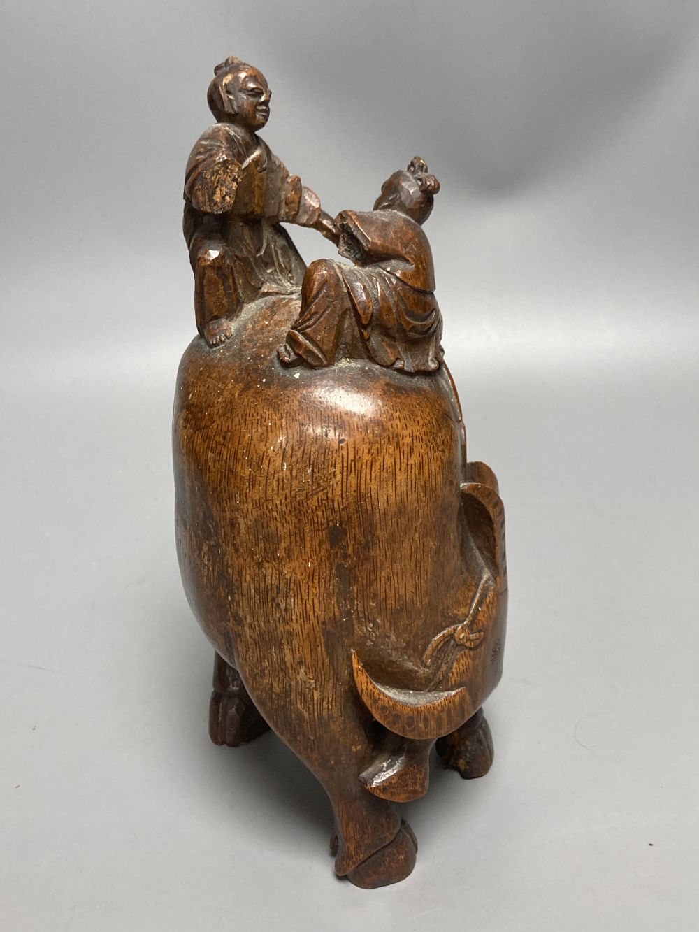 A Chinese bamboo group of figures on an ox and a wrist rest, 23 and 17cm